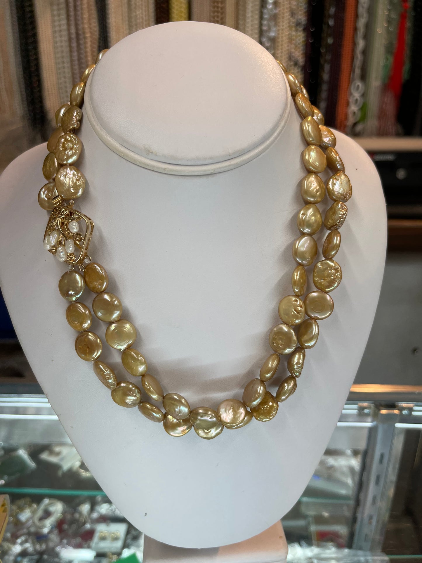 Two stands 19” knot golden coin fresh water pearls necklaces on delicate fancy gold clasp.